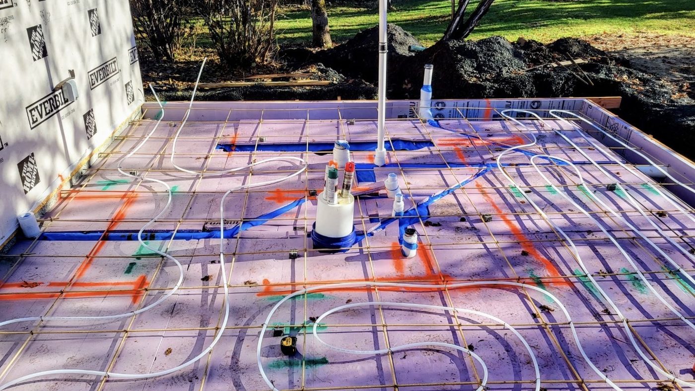 Hydronic in-floor heating tubing laid for a bathroom addition before the pour